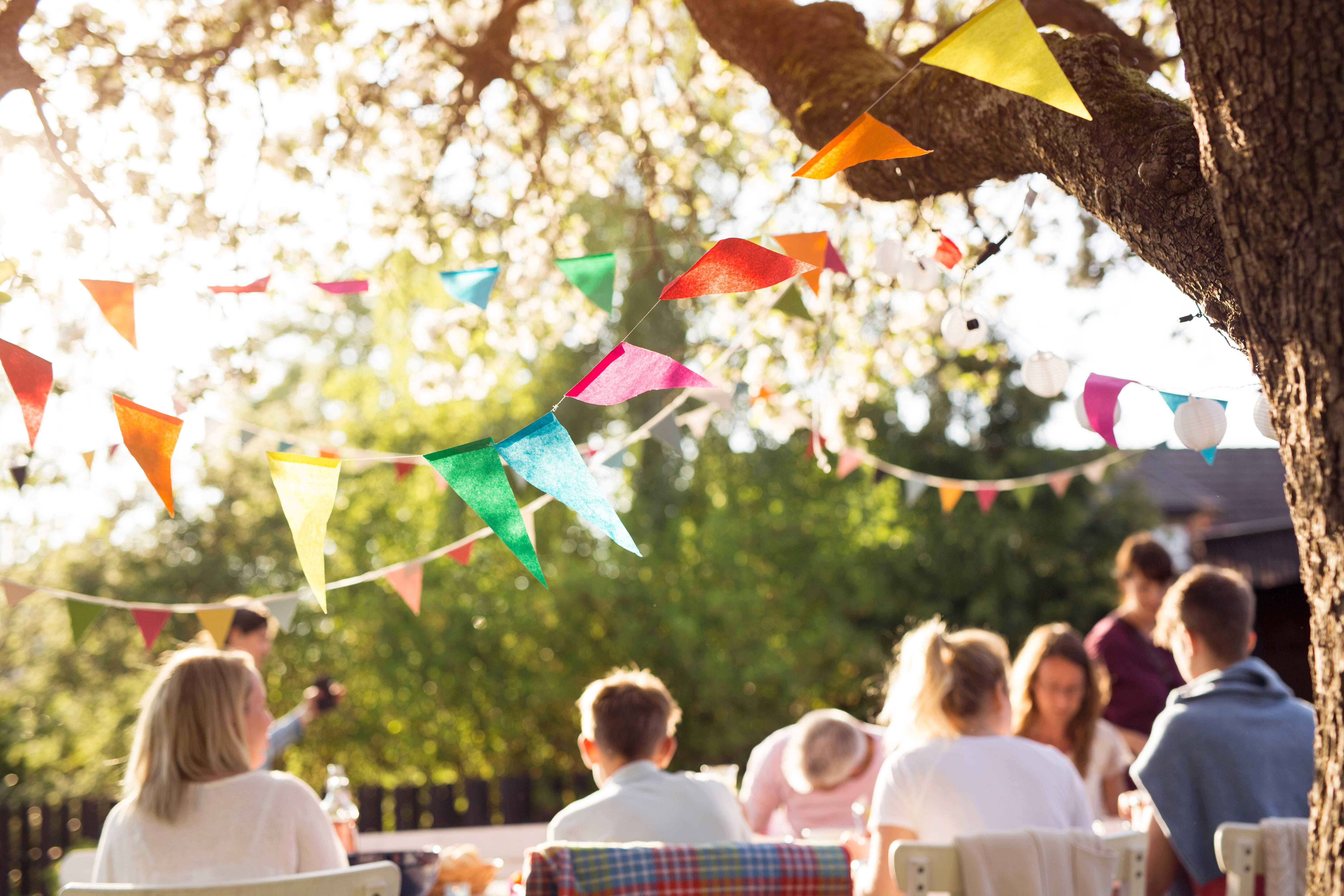 People enjoying a party outdoors after learning how to find local events in their area.