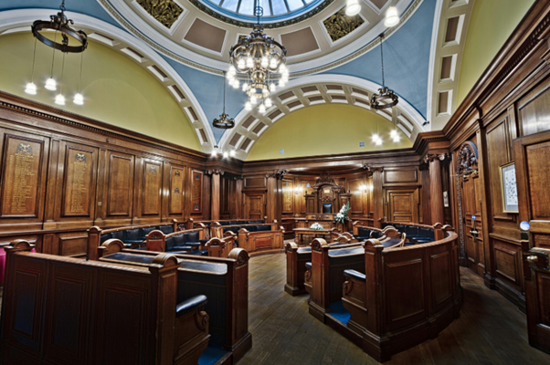 Council chamber interior representing local government reorganisation and its impact on elections and governance.